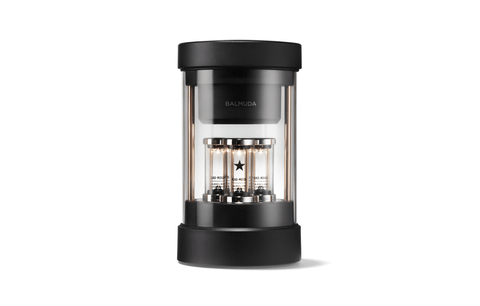 Black portable speaker with three glass cylinders, front