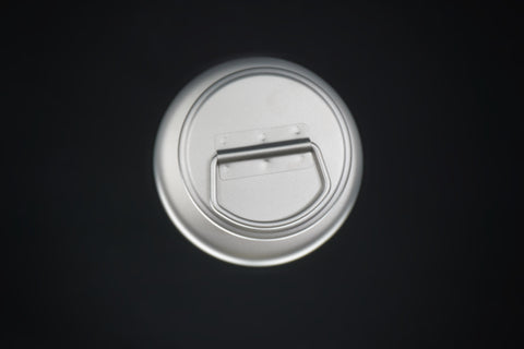 The bottle cap from above, its carry loop folded flat