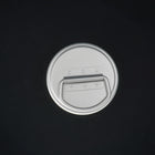 The bottle cap from above, its carry loop folded flat