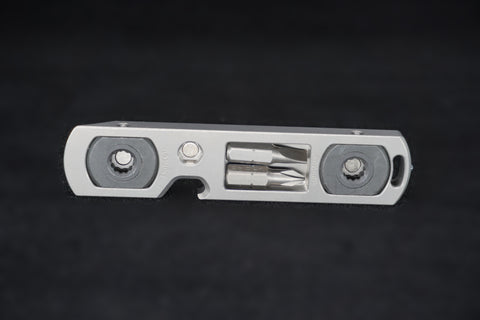 The bit driver at an angle, showing the hooked notch on its edge