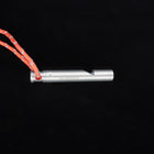 The whistle lying on its side, the lanyard looped through its end