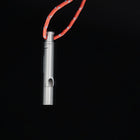 Titanium whistle hanging from its orange lanyard