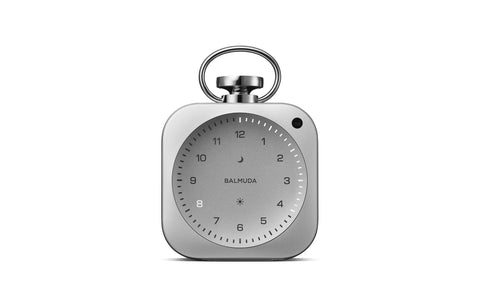 Silver pocket-watch-shaped desk clock, front, with a glowing hour numeral and light ring