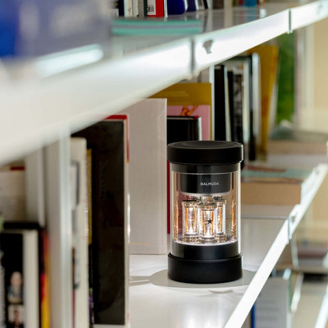 Speaker glowing on a bookshelf