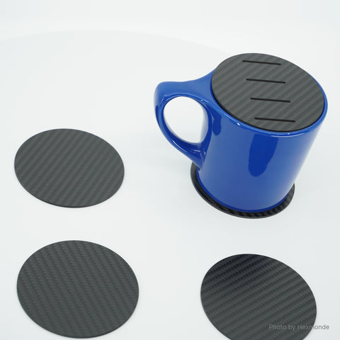 Slotted coaster on a mug, with three plain coasters