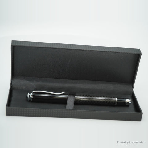 Pen in its black gift box with a carbon pattern