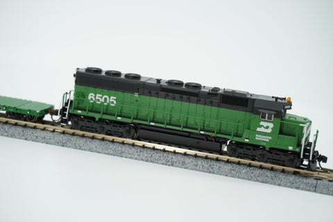 Side view of the Cascade Green Burlington Northern SD45 locomotive coupled to the flat car.