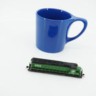 Side view of the Burlington Northern SD45 locomotive beside a blue mug for scale; mug is not included.