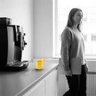 Yellow mug on a kitchen counter, the scene in black and white